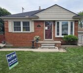 Brick home front elevation after roof replacement by AllPoint Construction