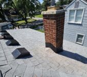 Roofing installation around chimney by AllPoint Construction