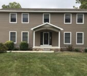 Two story home with new windows installed by AllPoint Construction