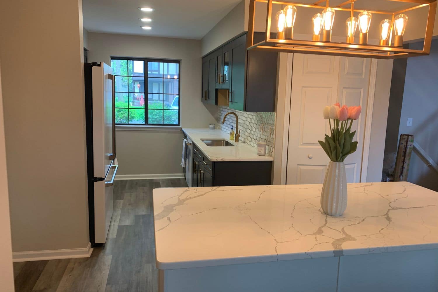 Kitchen island countertop installation illustrating how material choices impact remodel costs