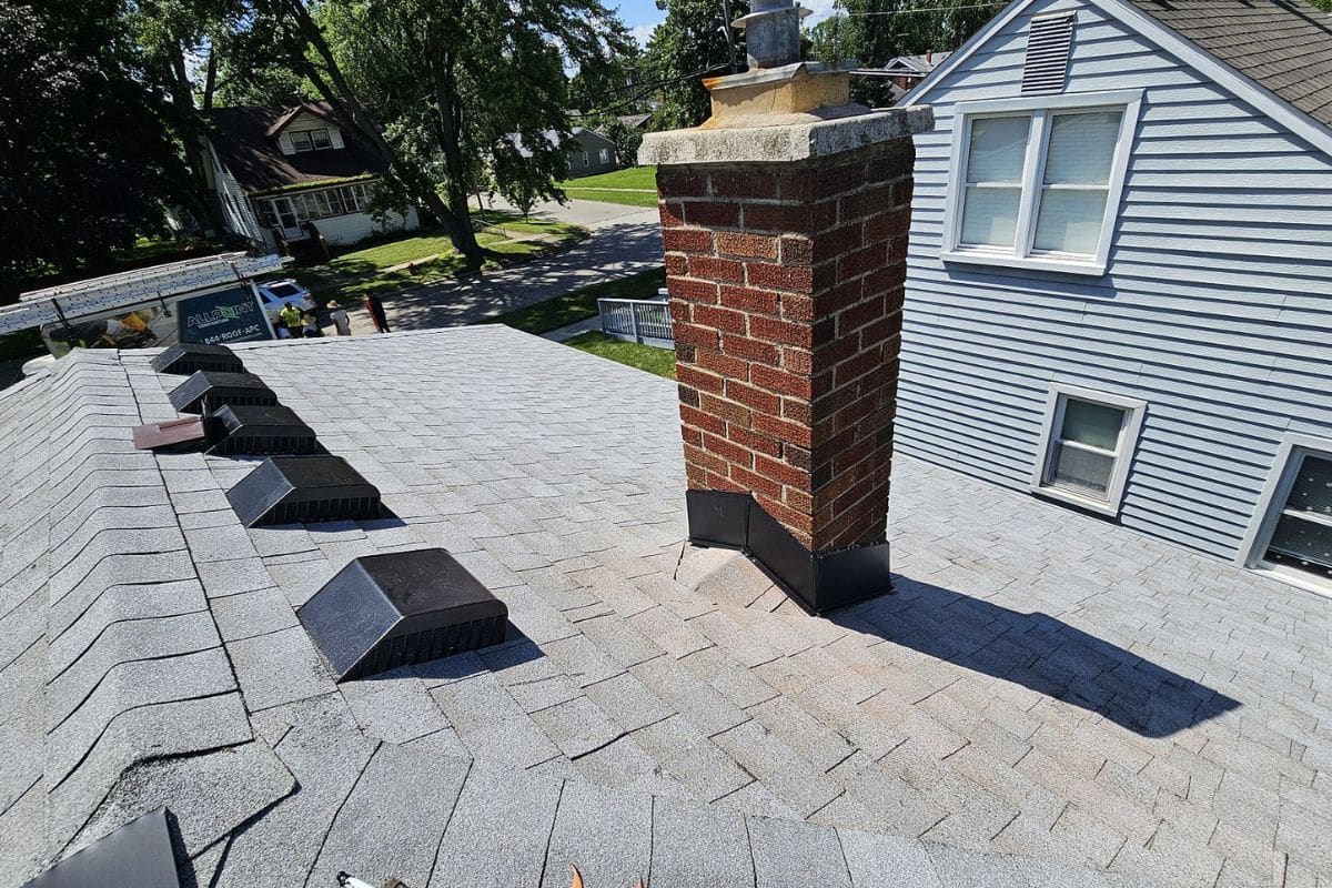 Professional roof inspection examining vents, flashing, and roof penetrations before tear-off